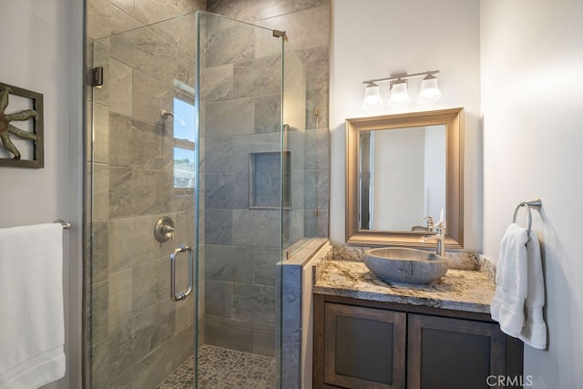 bathroom featuring walk in shower and vanity