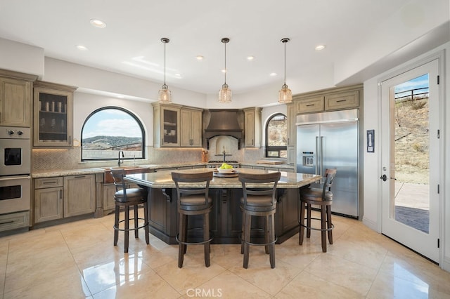 kitchen featuring pendant lighting, stainless steel appliances, and a healthy amount of sunlight