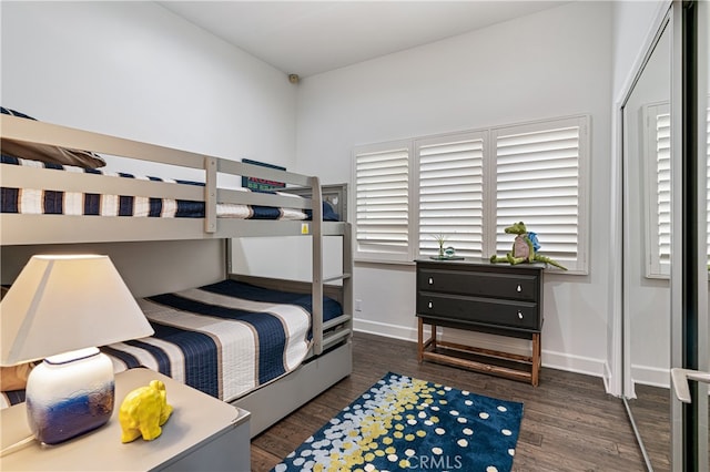 bedroom with dark hardwood / wood-style floors