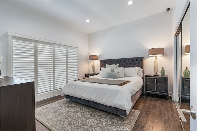 bedroom with dark hardwood / wood-style floors