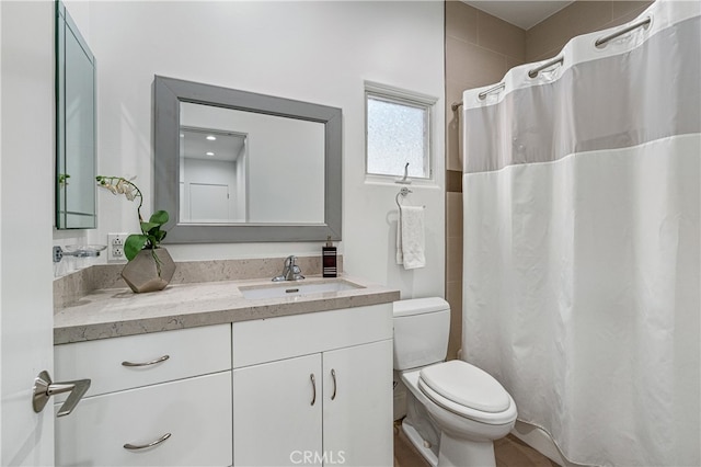 bathroom featuring walk in shower, vanity, and toilet