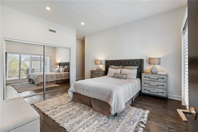 bedroom with a closet and dark hardwood / wood-style flooring