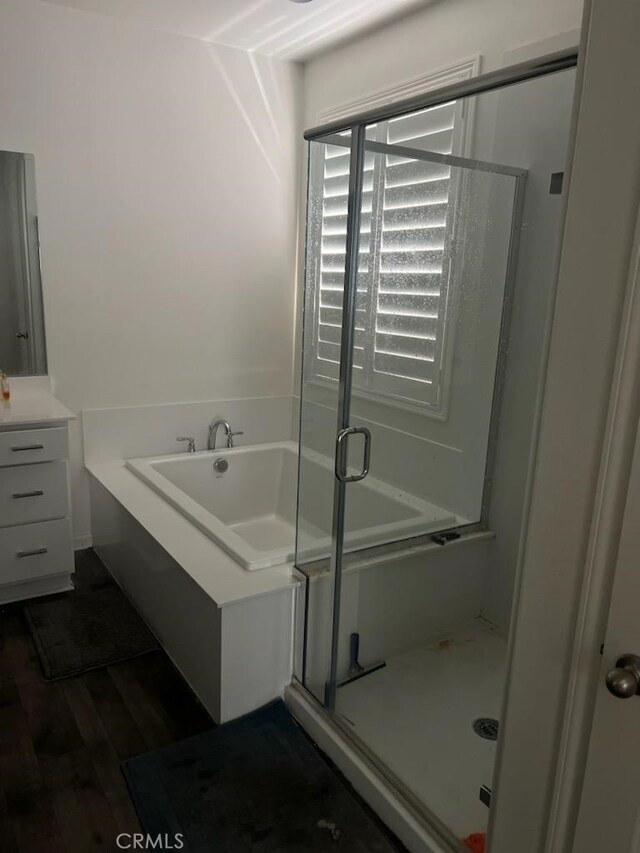 bathroom featuring hardwood / wood-style floors and a shower with door