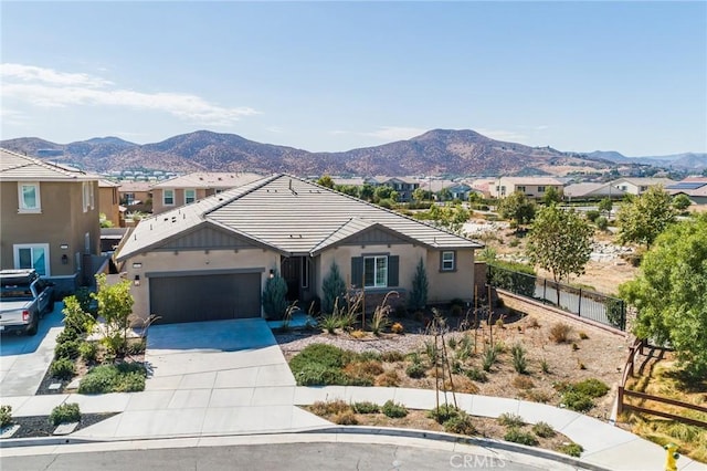 view of front of property featuring a mountain view and a garage