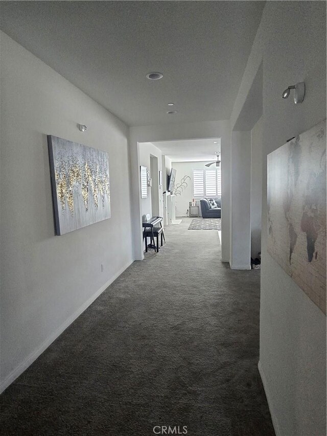 corridor with carpet flooring and a textured ceiling