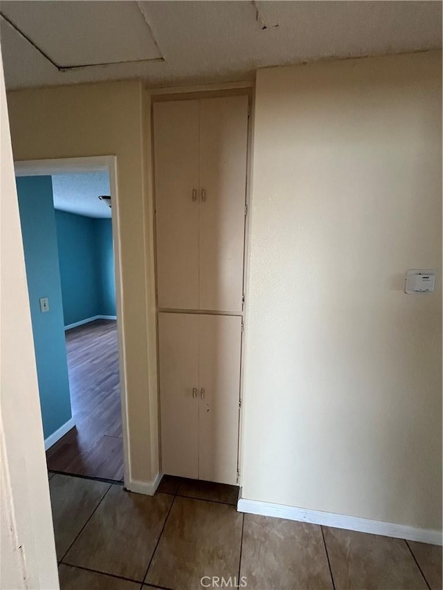 hallway with tile patterned floors