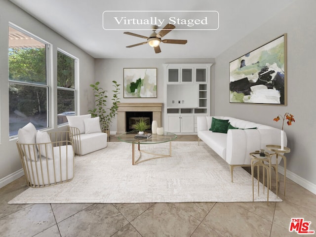 living room with ceiling fan and tile patterned flooring