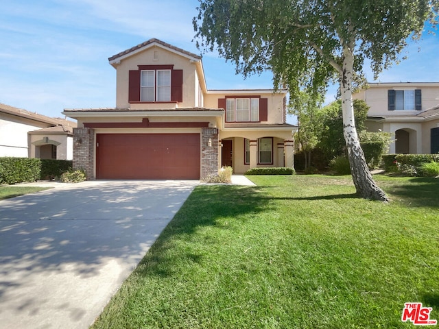 view of front of home with a front yard and a garage