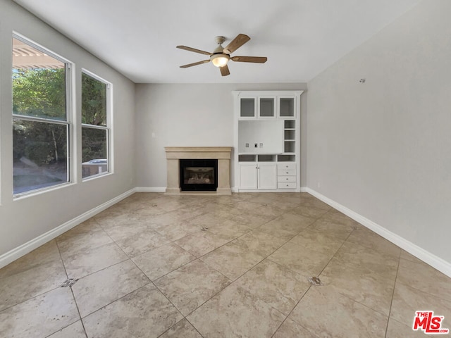 unfurnished living room with ceiling fan