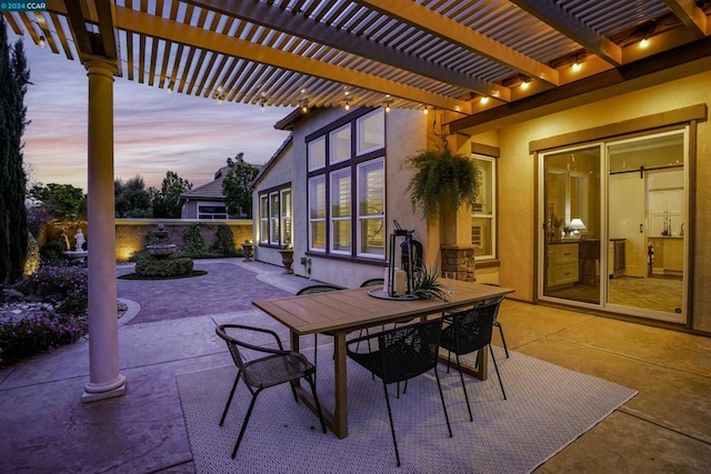 patio terrace at dusk featuring a pergola