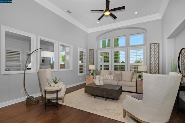 living room with a healthy amount of sunlight, ceiling fan, dark hardwood / wood-style flooring, and crown molding