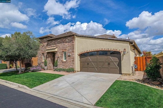 view of front of property featuring a garage and a front lawn