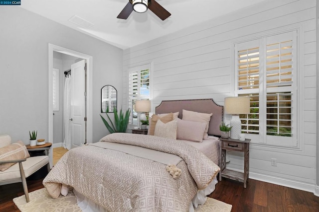 bedroom with ceiling fan and dark wood-type flooring