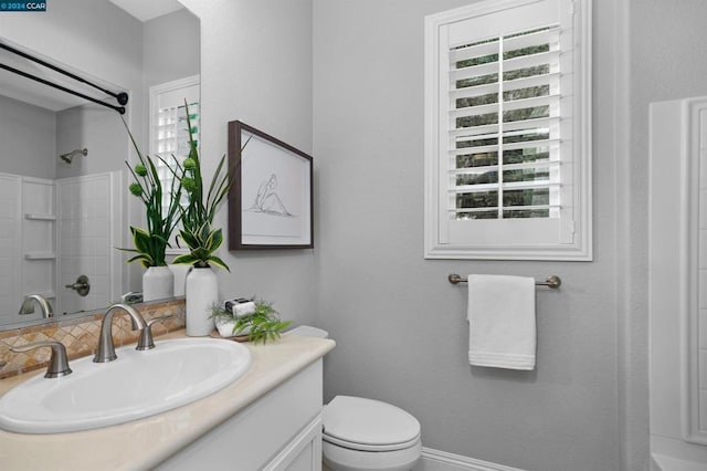 bathroom featuring vanity, toilet, and a shower