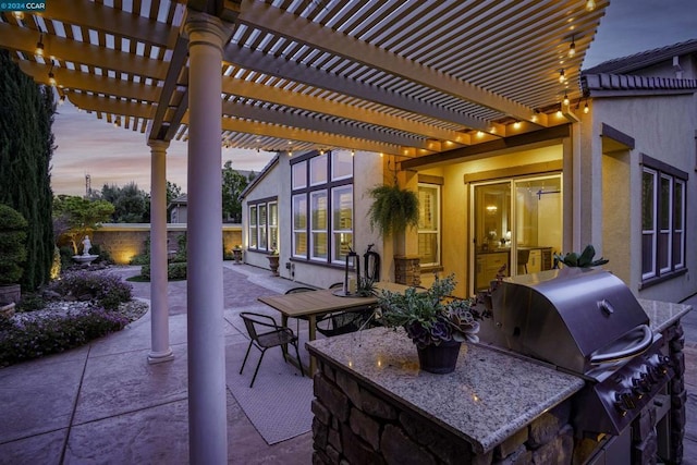 patio terrace at dusk with a pergola and grilling area