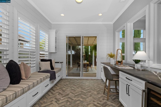 sunroom / solarium featuring a healthy amount of sunlight and beverage cooler