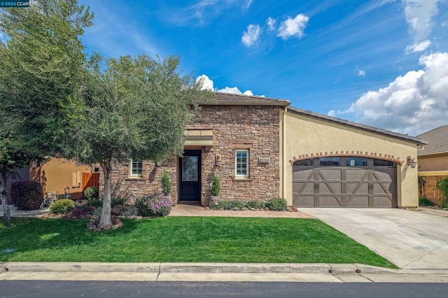 view of front facade with a garage and a front lawn