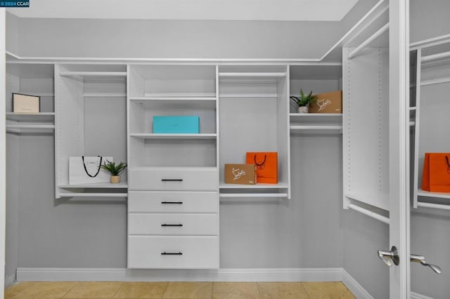 spacious closet with light tile patterned floors