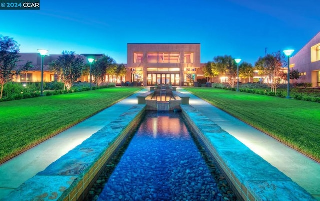 pool at dusk with a yard