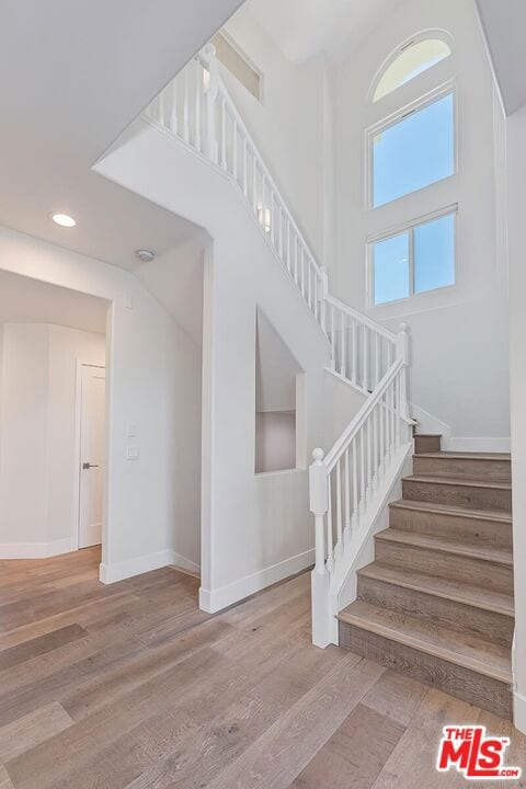 stairs featuring wood-type flooring