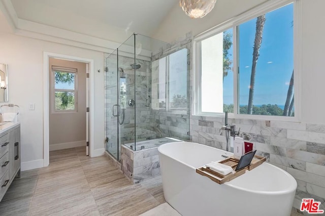 bathroom featuring independent shower and bath and vanity