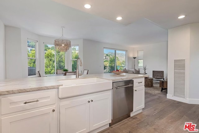 kitchen with a wealth of natural light, dishwasher, light hardwood / wood-style floors, and decorative light fixtures