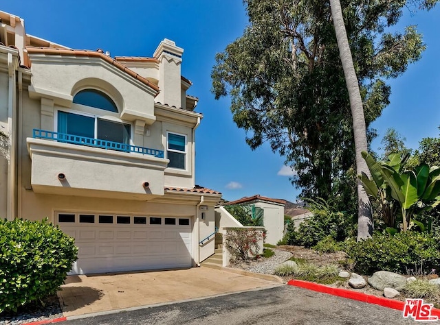 mediterranean / spanish-style home with a balcony and a garage