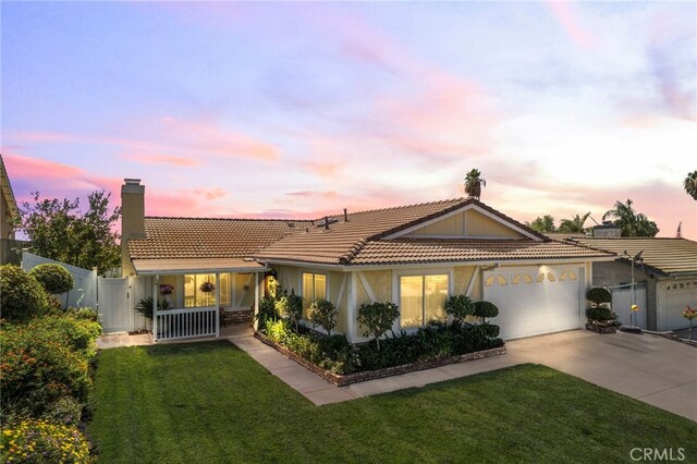 view of front of property with a lawn and a garage