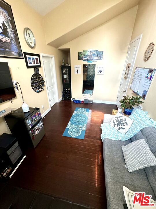 living room with lofted ceiling and dark hardwood / wood-style floors