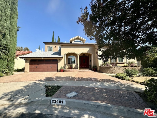 mediterranean / spanish home with a garage