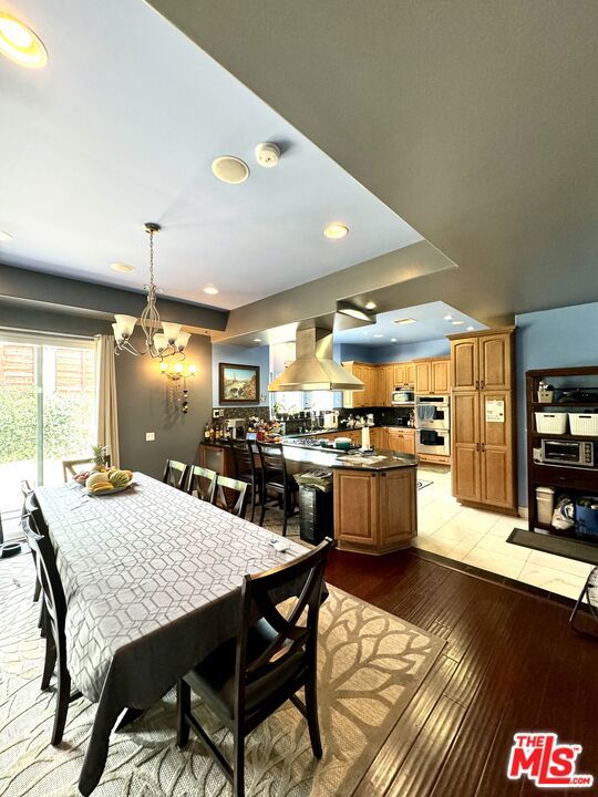 dining room featuring light hardwood / wood-style floors and an inviting chandelier