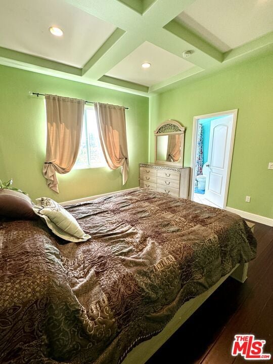 bedroom with beam ceiling, coffered ceiling, and dark wood-type flooring