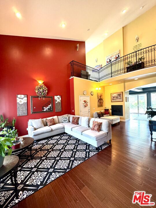 living room featuring a high ceiling and hardwood / wood-style floors