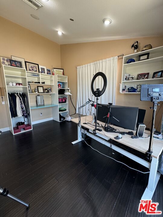 interior space with lofted ceiling and hardwood / wood-style flooring