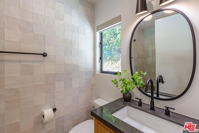 bathroom featuring vanity and toilet