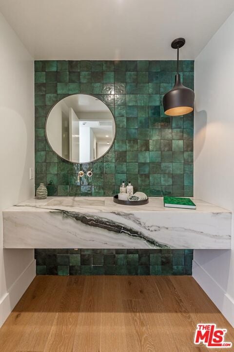 bathroom featuring hardwood / wood-style flooring and backsplash