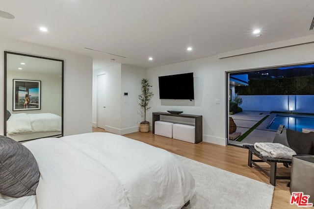 bedroom with light hardwood / wood-style flooring and access to exterior