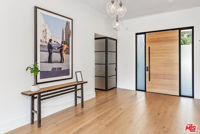 interior space with an inviting chandelier and hardwood / wood-style floors