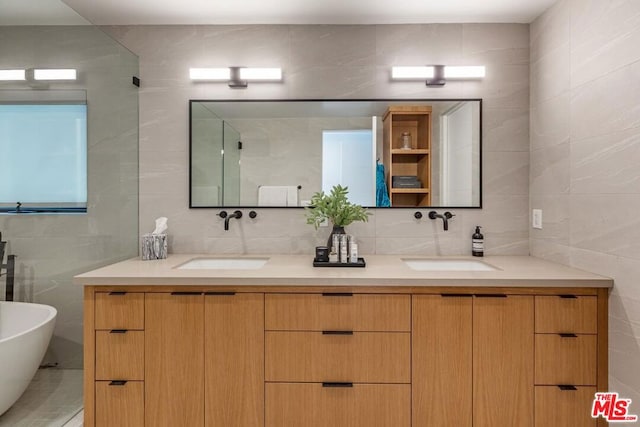 bathroom featuring tile walls, backsplash, vanity, and shower with separate bathtub