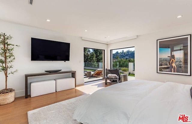 bedroom featuring light hardwood / wood-style flooring and access to exterior