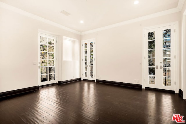 spare room with french doors, ornamental molding, and dark wood-type flooring