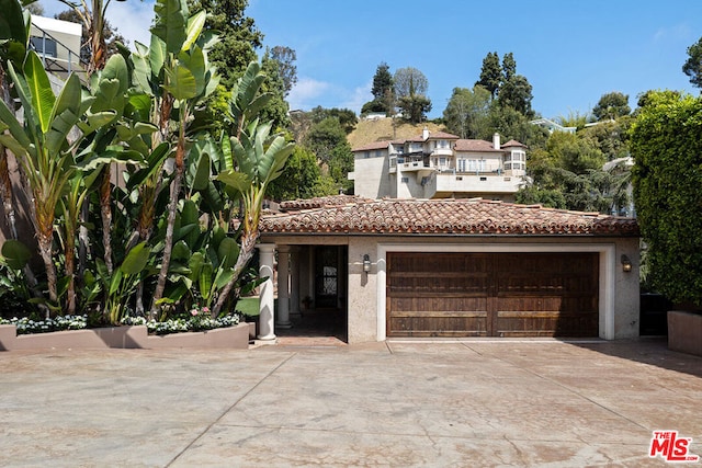 mediterranean / spanish-style house with a garage