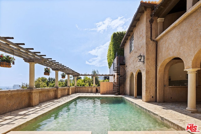 view of pool featuring a patio and a pergola