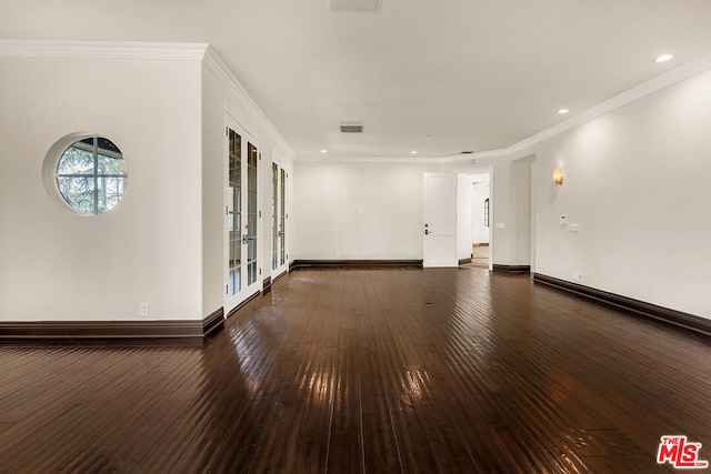 unfurnished room with crown molding, dark hardwood / wood-style floors, and french doors