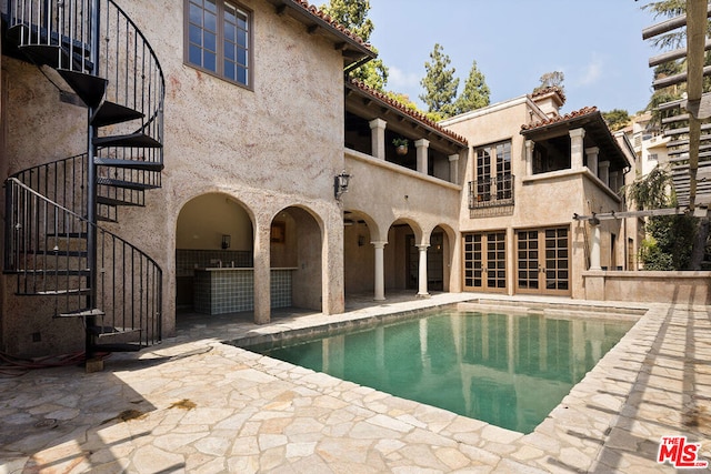 view of swimming pool with a patio