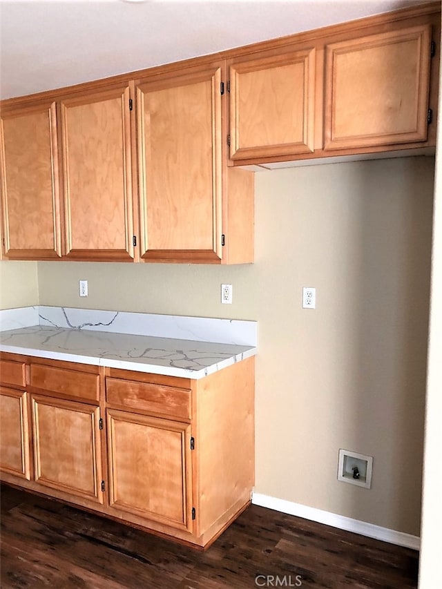 kitchen featuring light stone countertops and dark hardwood / wood-style floors