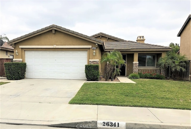 view of front of home featuring a garage and a front lawn