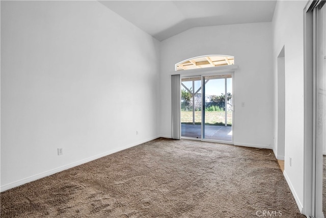 carpeted empty room with lofted ceiling