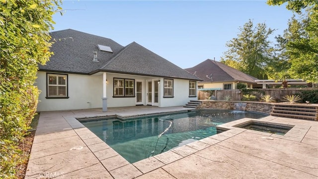 view of pool with an in ground hot tub, french doors, and a patio