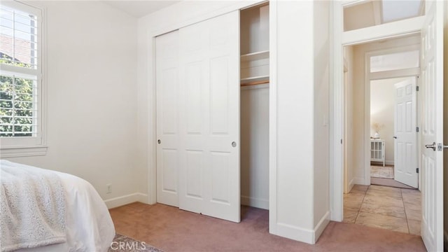 carpeted bedroom featuring a closet